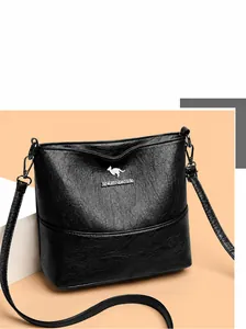 Detailed macro view of litchi textured leather and kangaroo metal logo on black bucket bag