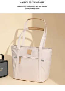 Detail of minimalist waterproof tote bag with brown straps and detachable shoulder strap