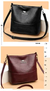 Detail view of large leather bucket bags in black and burgundy with metallic kangaroo logo