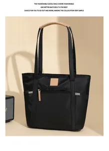 Detail of waterproof nylon tote bag showing front zipper pocket and khaki PU trim