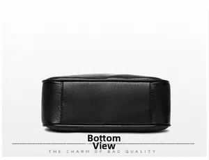 Detail view of the rectangular bottom of the black leather bag with precise stitching
