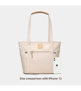 Minimalist beige tote bag size comparison with an iPhone 12 to show large capacity