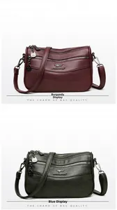 Detail view of burgundy and teal multi-zipper leather crossbody bags with kangaroo logo