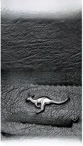 Macro shot of black lychee grain leather texture and metallic kangaroo brand logo detail