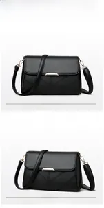 Front and side view of black lychee grain leather crossbody bag with gold metal buckle