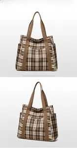 Detail of checkered canvas tote bag with wide shoulder strap and side storage pocket