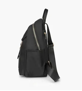 Side view of black nylon backpack with golden metal zippers and side storage pocket