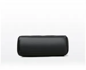 Detailed view of the black lychee pattern leather base with clean stitching on small bag