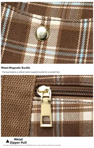 Detail of high-quality gold metal magnetic snap and zipper on brown plaid tote bag