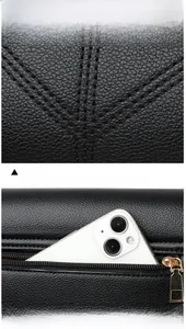 Close-up of black lychee grain leather bag with a functional golden metal back zipper pocket