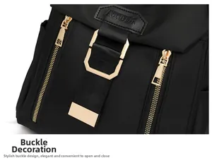 Close-up of black nylon backpack featuring gold metal buckles and ATULZ leather logo