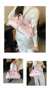 Detail of light pink wrinkled texture tote bag with double straps and metallic buckle