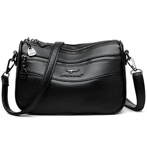 Classic black leather crossbody bag with multi-layer zipper design and silver hardware