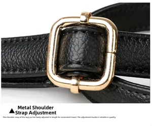 Detail of lychee pattern leather strap with adjustable light gold metal buckle for bags