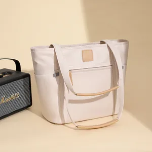 Minimalist large-capacity nylon tote bag with leather handles in a chic cream white finish