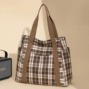 Brown checkered canvas tote bag with wide shoulder straps and large storage capacity
