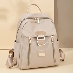 Waterproof nylon travel backpack in beige with front buckle and adjustable straps