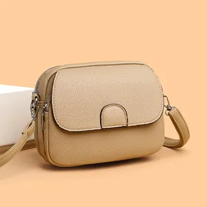 Chic beige crossbody mini bag with lychee texture and silver hardware on a soft background