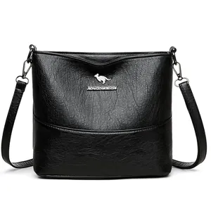 Minimalist black bucket bag with wide strap and silver kangaroo metal logo detail