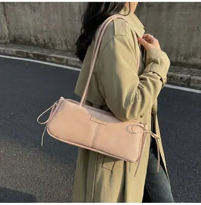 Detail of light pink Boston bag with knot drawstring and Fashion & Bags brand tag