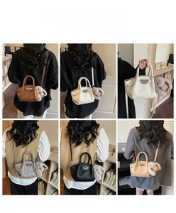 Detailed back view of six colored bucket bags featuring plush bunny charms and silver buckles