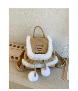 Detail of cute cat embroidery and white faux fur trim on a brown mini plush backpack