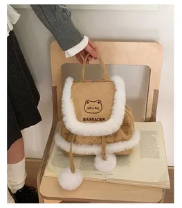 Detail of a brown corduroy backpack with white faux fur trim and cute cat embroidery