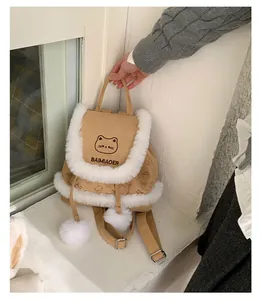 Detail of cute cat pattern on plush khaki backpack with soft white faux fur trim