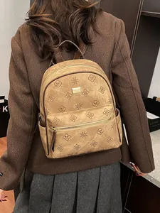 Brown embossed faux leather backpack for women with clover pattern and front zipper pocket