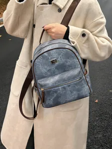 Light blue embossed clover pattern backpack with brown straps for casual daily use