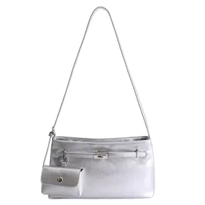 Metallic silver underarm bag with decorative belt buckle and small matching pouch