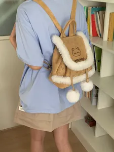 Faux fur trimmed suede cat-themed backpack for women in brown with white pom-pom charms