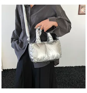 Modern metallic silver quilted tote bag styled with casual outfit on high-quality model