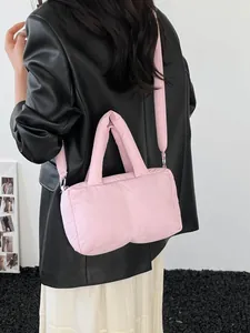Pink puffer tote bag with quilted texture and adjustable shoulder strap for women