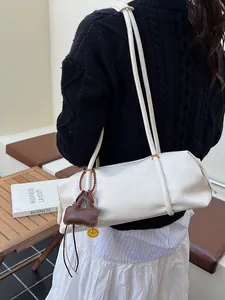 White lychee leather Boston tote bag with shoulder straps and yellow smiley charm