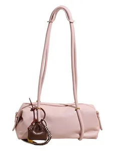 Pink minimalist cylindrical baguette tote bag with a small brown charm accessory