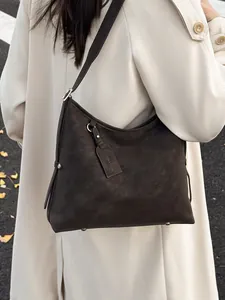 Retro large capacity tote bag in coffee brown leather styled with a trench coat