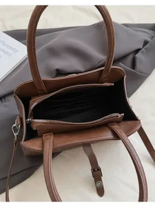 Top view showing the internal multi-layer storage and smooth zipper of the brown tote bag