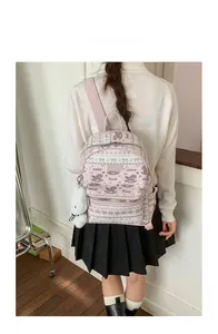 Detail of pink backpack with cute foal print and white plush bunny keychain on back