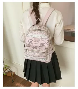 Close-up of pink and cream faux leather backpack with cute bow and foal prints