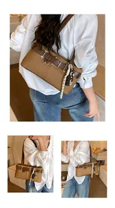 Detail of khaki canvas and leather Boston bag with woven rope and chain charms