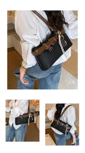 Detail of retro color-block shoulder bag featuring brown strap buckle and chocolate pendant