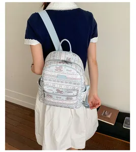 Detail view of the light blue backpack featuring a cute horse and bow print on the back