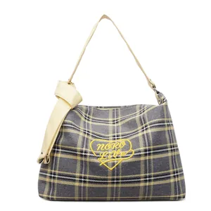 Plaid canvas tote bag with yellow heart embroidery and leather straps in a casual style