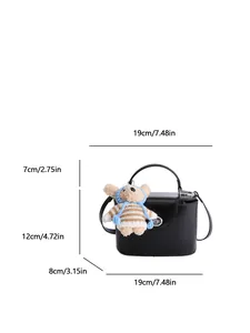 Minimalist black square crossbody bag with top handle and cute plush bear charm