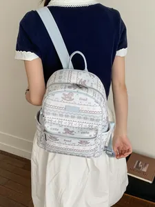 Chic light blue printed backpack for women with cute foal and bow motifs in a lifestyle setting