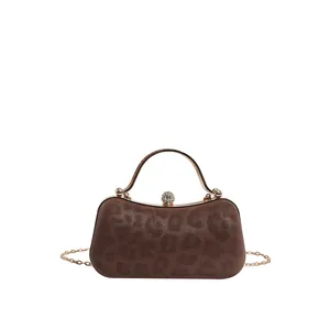 Brown leopard print evening bag with golden metal handle and crystal ball clasp