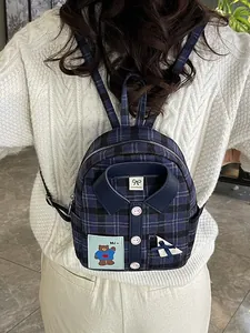 Plaid blue tweed mini backpack with shirt collar design and bear patch on white sweater