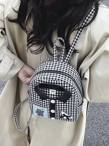 Mini black and white checkered canvas backpack with shirt collar and pink buttons