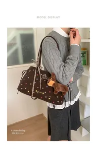 Detail of canvas tote bag with star patterns, bow knot and brown puppy plush charm